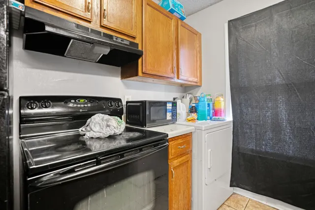 a bathroom with a sink a toilet and shower curtain