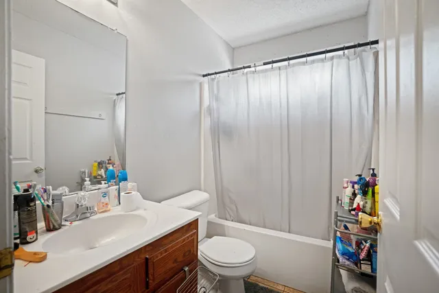 a bedroom with furniture and a large window