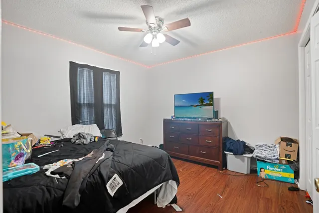 a view of a house with a yard and large trees