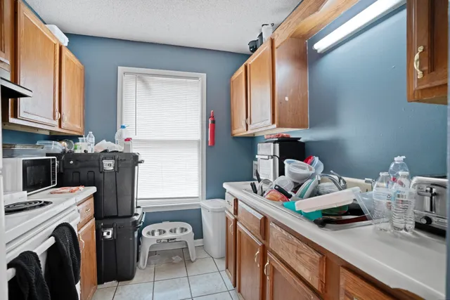 a kitchen with a stove a sink and a microwave