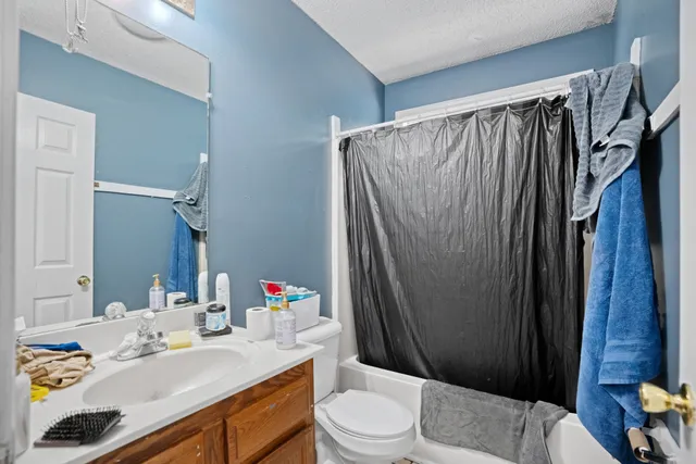 a view of a bedroom with bed and toys