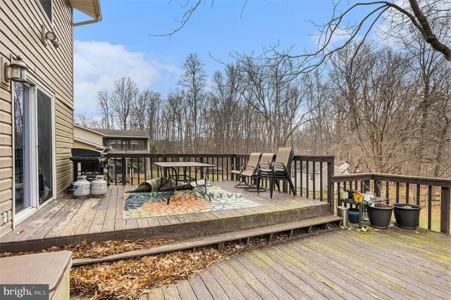 a view of balcony with wooden floor and seating space
