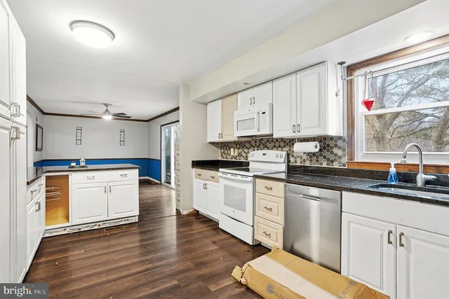 a bathroom with a sink vanity mirror and toilet