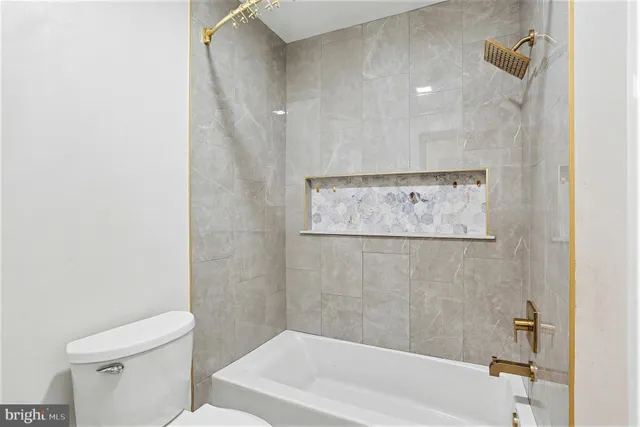 a bathroom with a bathtub and a toilet