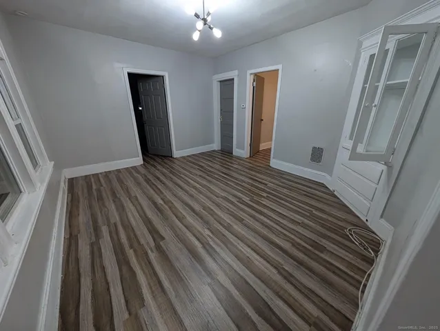 a view of a room with wooden floor and staircase