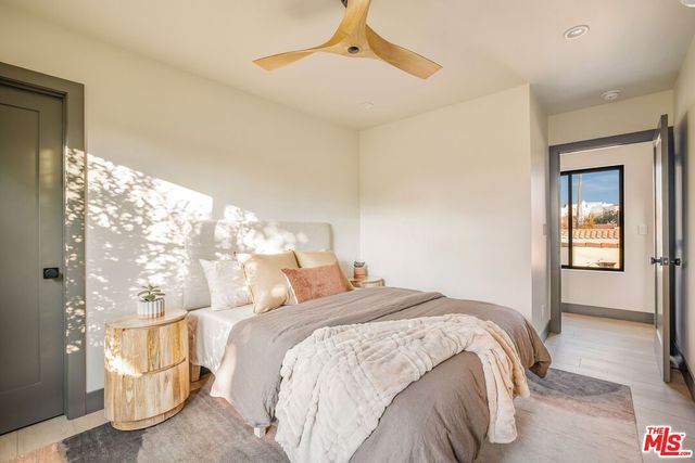 a bedroom with a bed and a large window