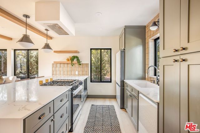 a bathroom with a granite countertop double vanity sink a mirror and a bathtub