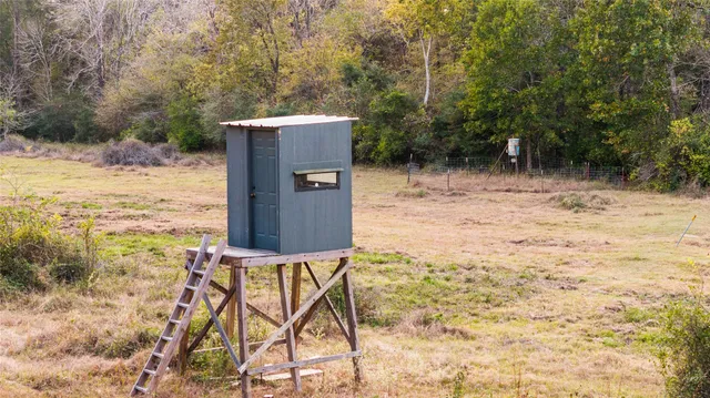 a view of a yard with wooden fence