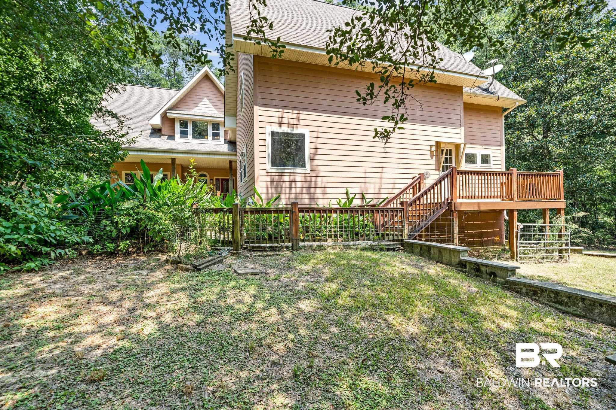 8321 Dixon Road Bay Minette, AL 36507 - Photo 12 of 79 Rear view of property with a deck and a lawn