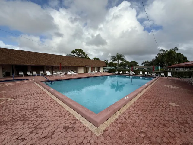 a view of a swimming pool with lawn chairs