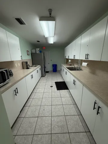 a kitchen with stainless steel appliances a sink a stove a microwave and cabinets