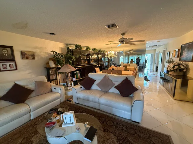 a living room with furniture and floor to ceiling windows