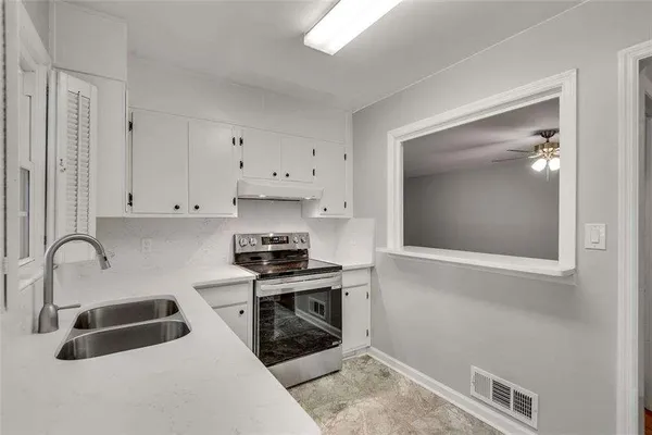 a kitchen with a refrigerator and a sink