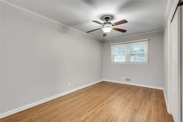 a view of an empty room and wooden floor