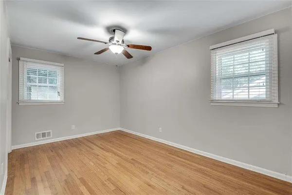 a view of an empty room with wooden floor