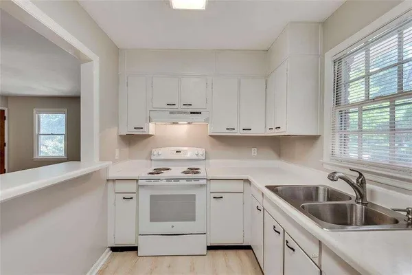 a kitchen with a refrigerator and a sink
