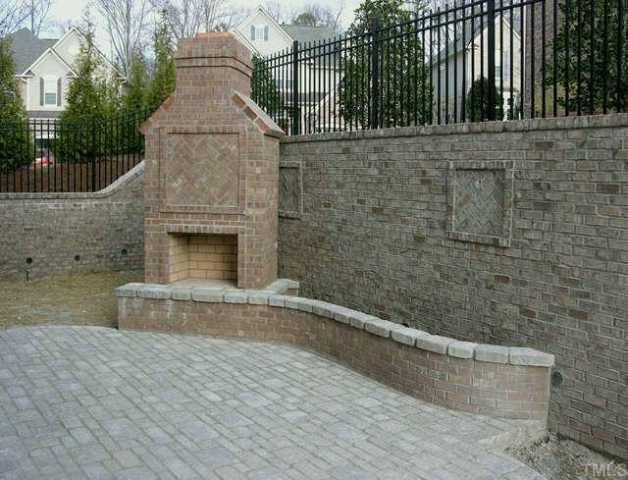 3924 Morvan Way Raleigh, NC 27612 - Photo 11 of 11 Lovely outdoor living space with a mortared stone patio, outdoor fireplace, planting bed and plumbed for a water feature. Wrought iron like aluminum fencing with 1 gate. Other