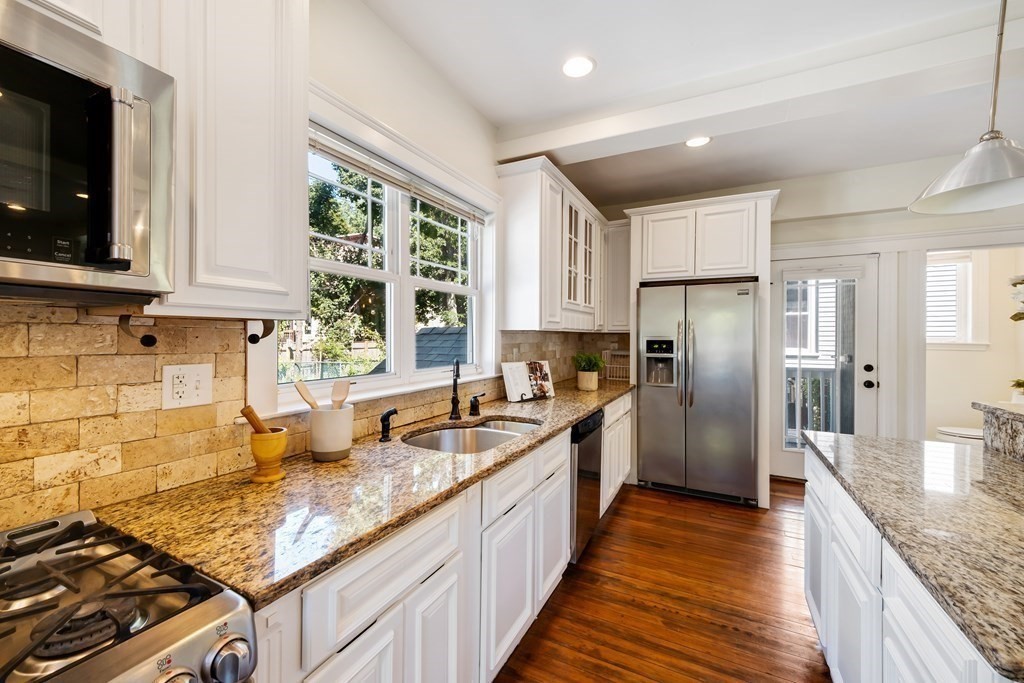 39 Rosedale Street Boston, MA 02124 - Photo 11 of 42 a kitchen with stainless steel appliances granite countertop a sink stove and refrigerator