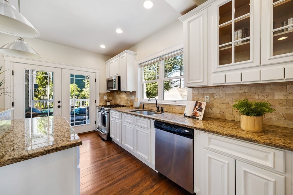 39 Rosedale Street Boston, MA 02124 - Photo 12 of 42 a kitchen with stainless steel appliances granite countertop a sink and wooden cabinets
