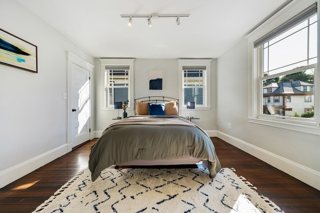 39 Rosedale Street Boston, MA 02124 - Photo 19 of 42 a bedroom with a bed and wooden floor