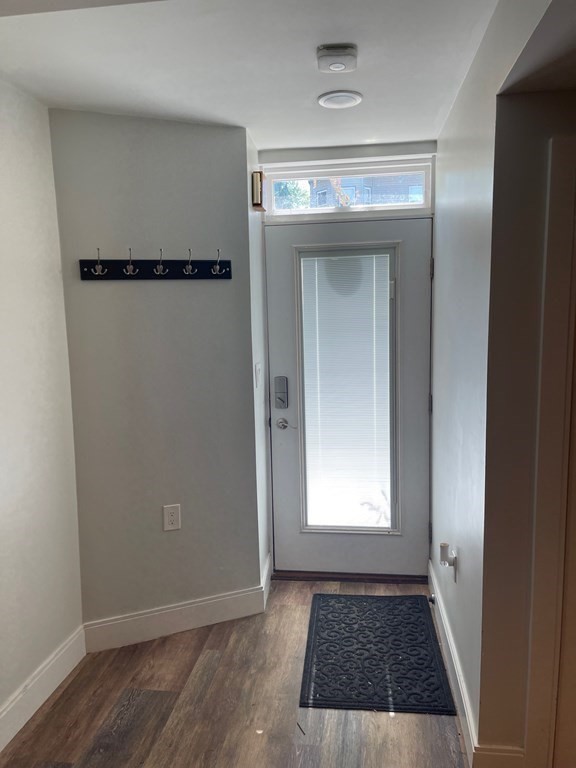 39 Rosedale Street Boston, MA 02124 - Photo 32 of 42 a view of an empty room with wooden floor and a window