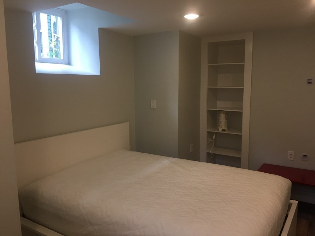 39 Rosedale Street Boston, MA 02124 - Photo 37 of 42 a bedroom with a bed and a window