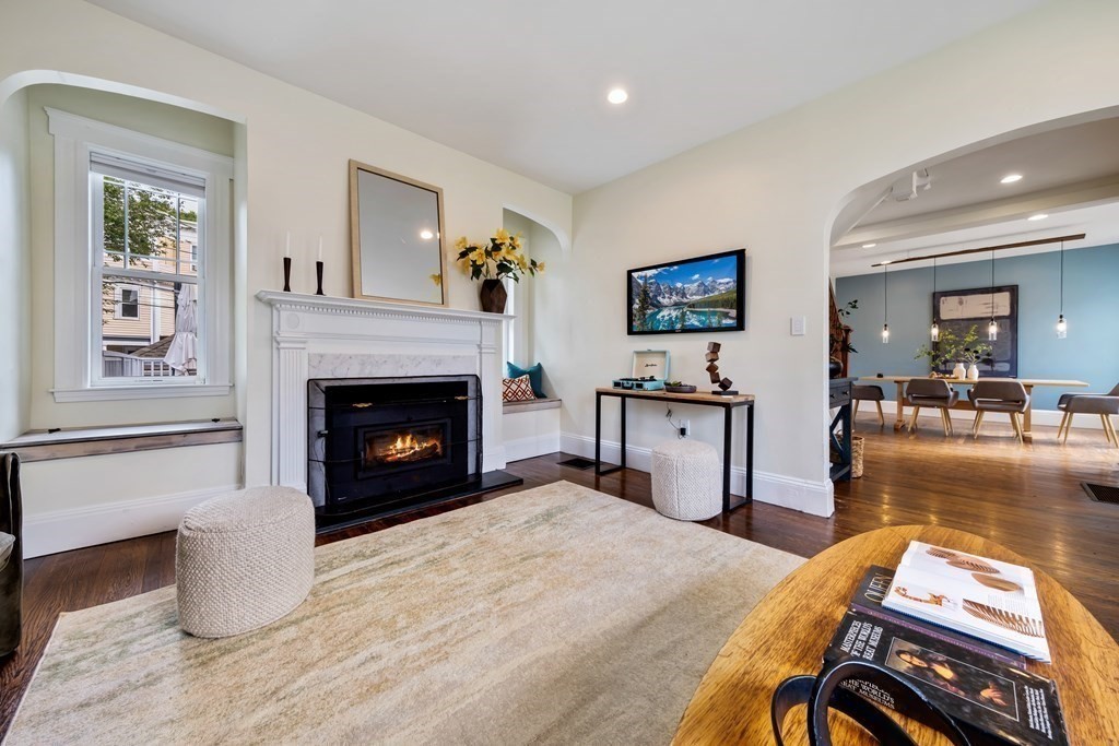 39 Rosedale Street Boston, MA 02124 - Photo 5 of 42 a living room with furniture a flat screen tv and a fireplace