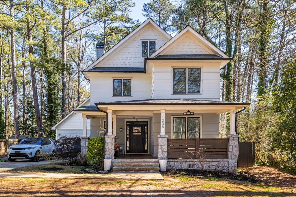 1208 Conway Road Decatur, GA 30030 - Photo 1 of 1 a front view of a house with a yard and garage