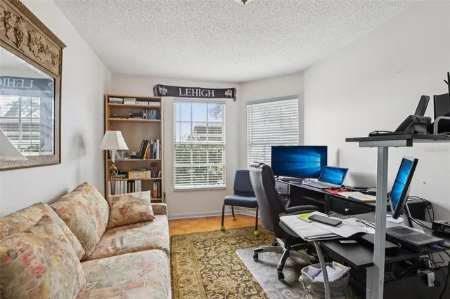 a living room with furniture a piano and a window