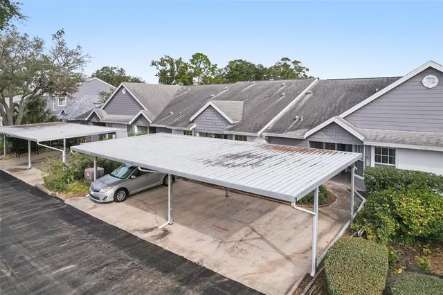 an aerial view of a house with swimming pool and outdoor seating