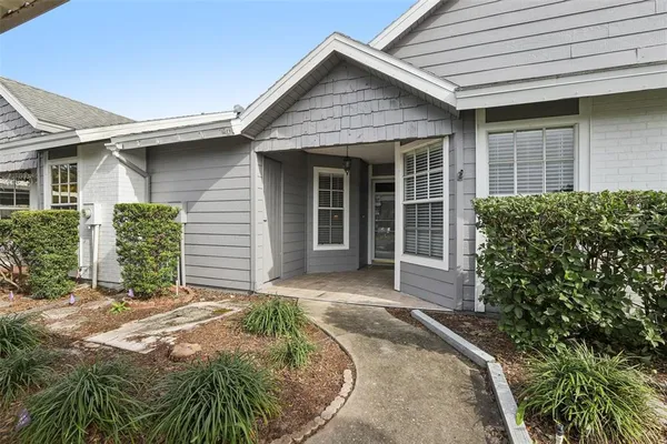 front view of a house with yard and plants