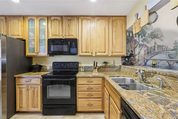 a kitchen with a stove a sink and a cabinet
