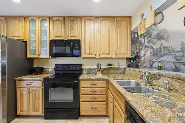 a kitchen with a stove a sink and a cabinet