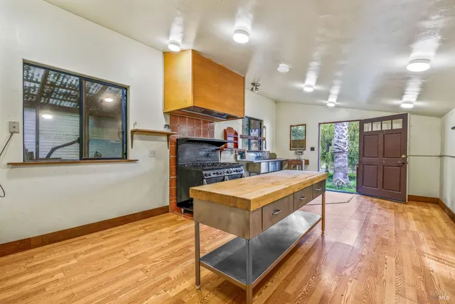 a large kitchen with stainless steel appliances granite countertop a stove and a refrigerator