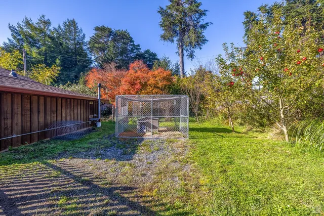 a view of yard with wooden fence