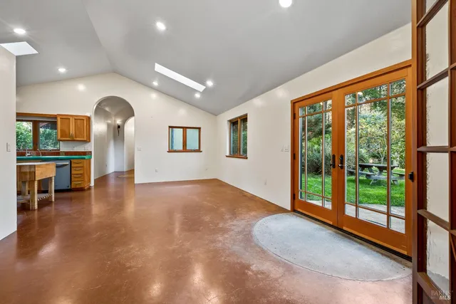 a view of a livingroom with furniture wooden floor and windows