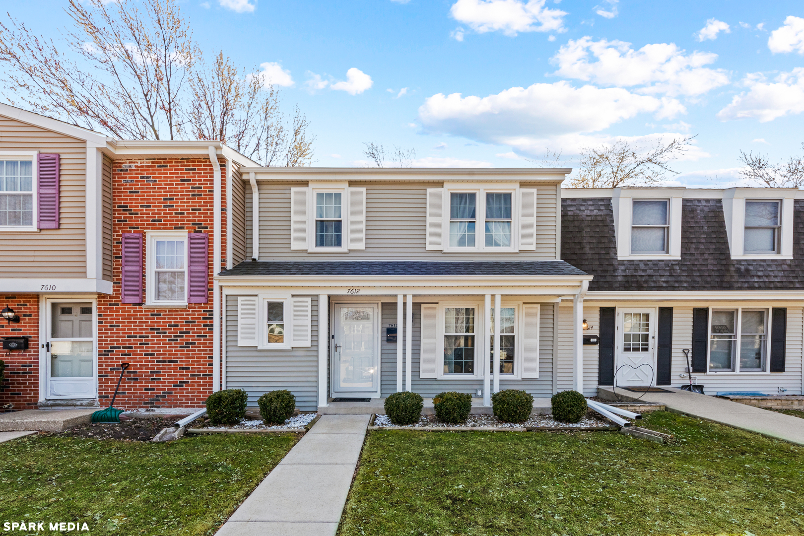 7612 Manchester Manor Hanover Park, IL 60133 - Photo 1 of 30 a front view of a house with a yard