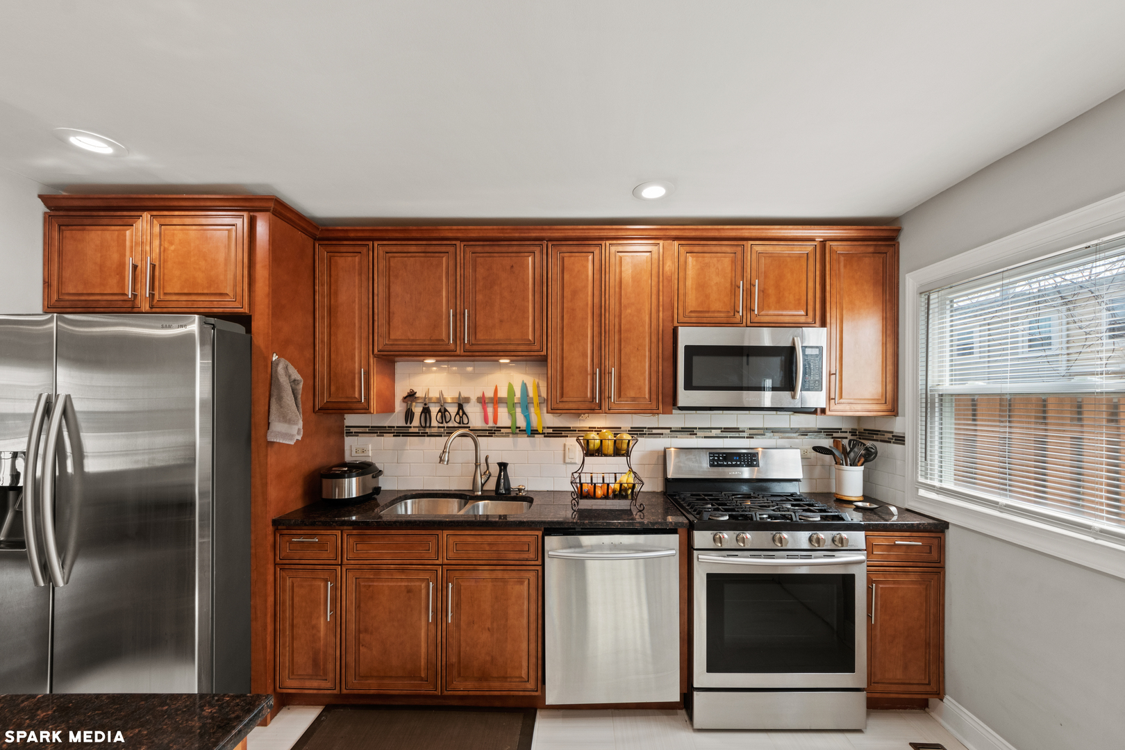 7612 Manchester Manor Hanover Park, IL 60133 - Photo 11 of 30 a kitchen with stainless steel appliances granite countertop a refrigerator stove and microwave