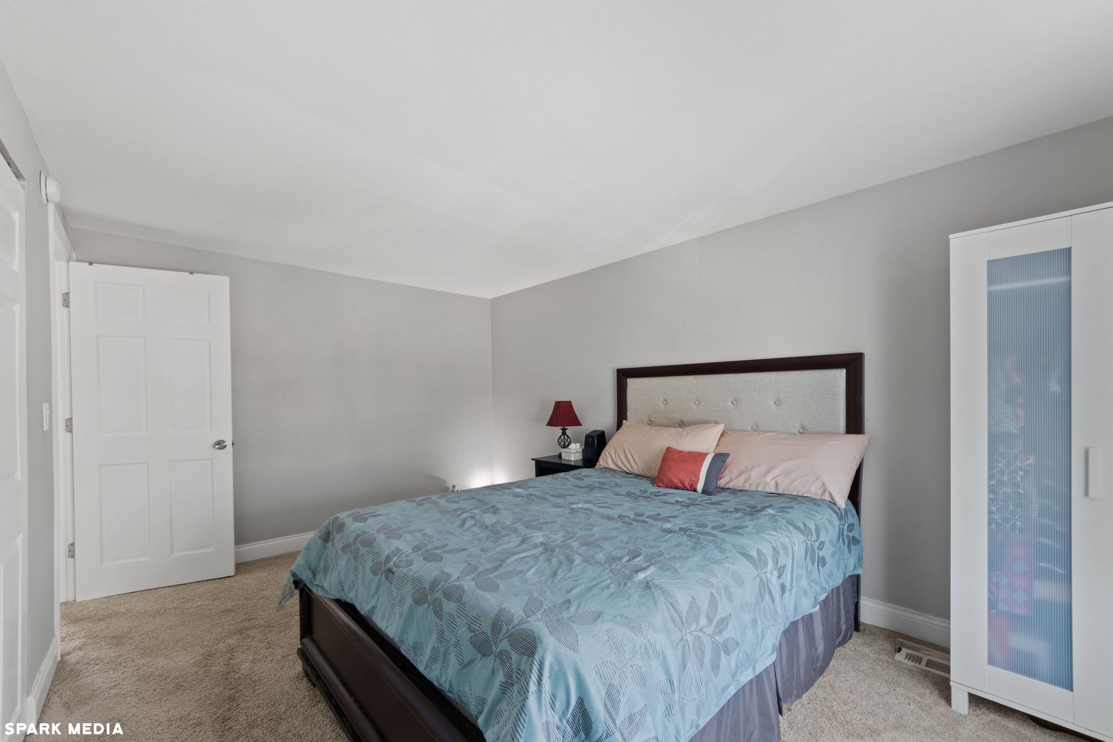 7612 Manchester Manor Hanover Park, IL 60133 - Photo 15 of 30 a bedroom with a bed and a night stand