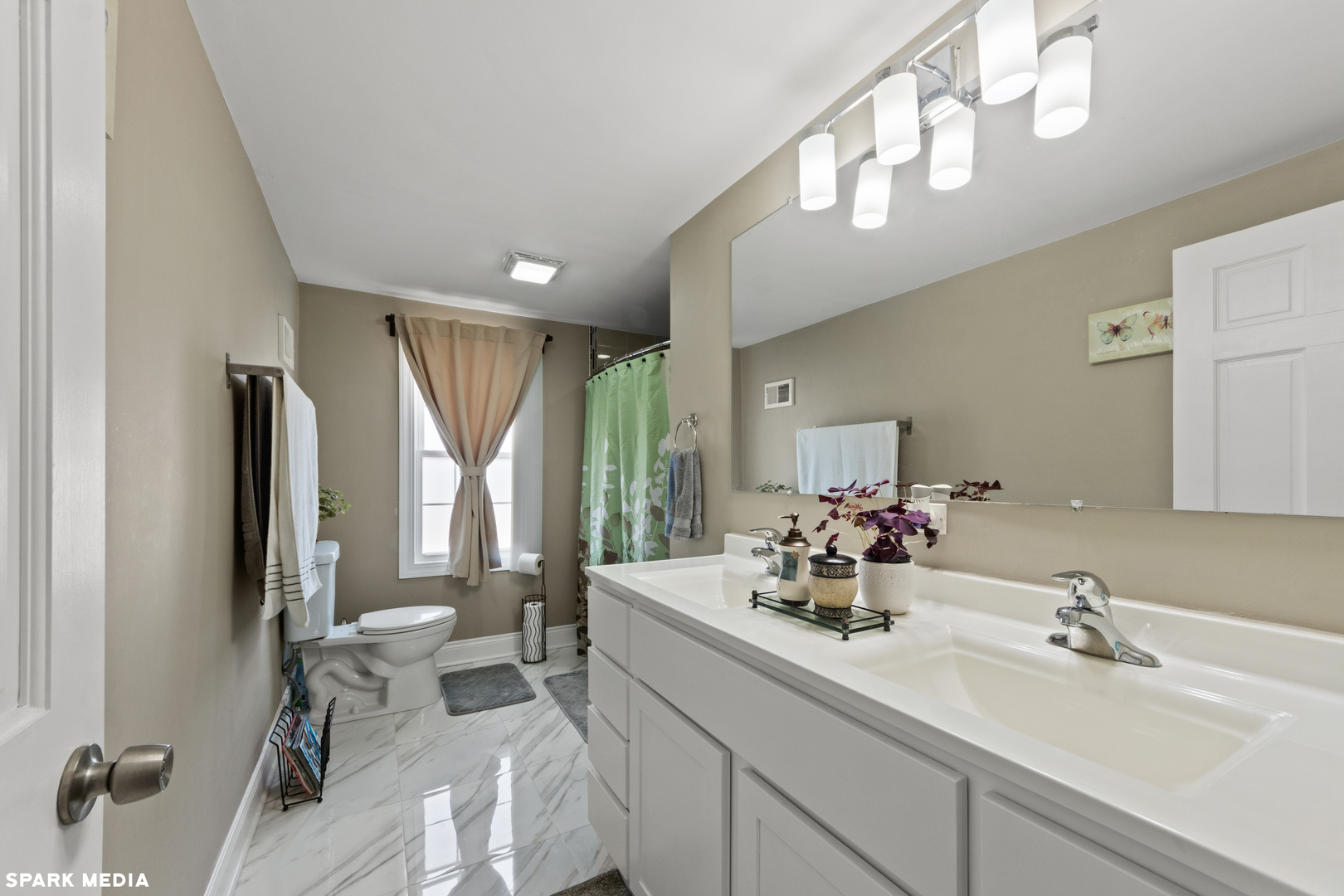 7612 Manchester Manor Hanover Park, IL 60133 - Photo 16 of 30 a bathroom with a double vanity sink and a mirror