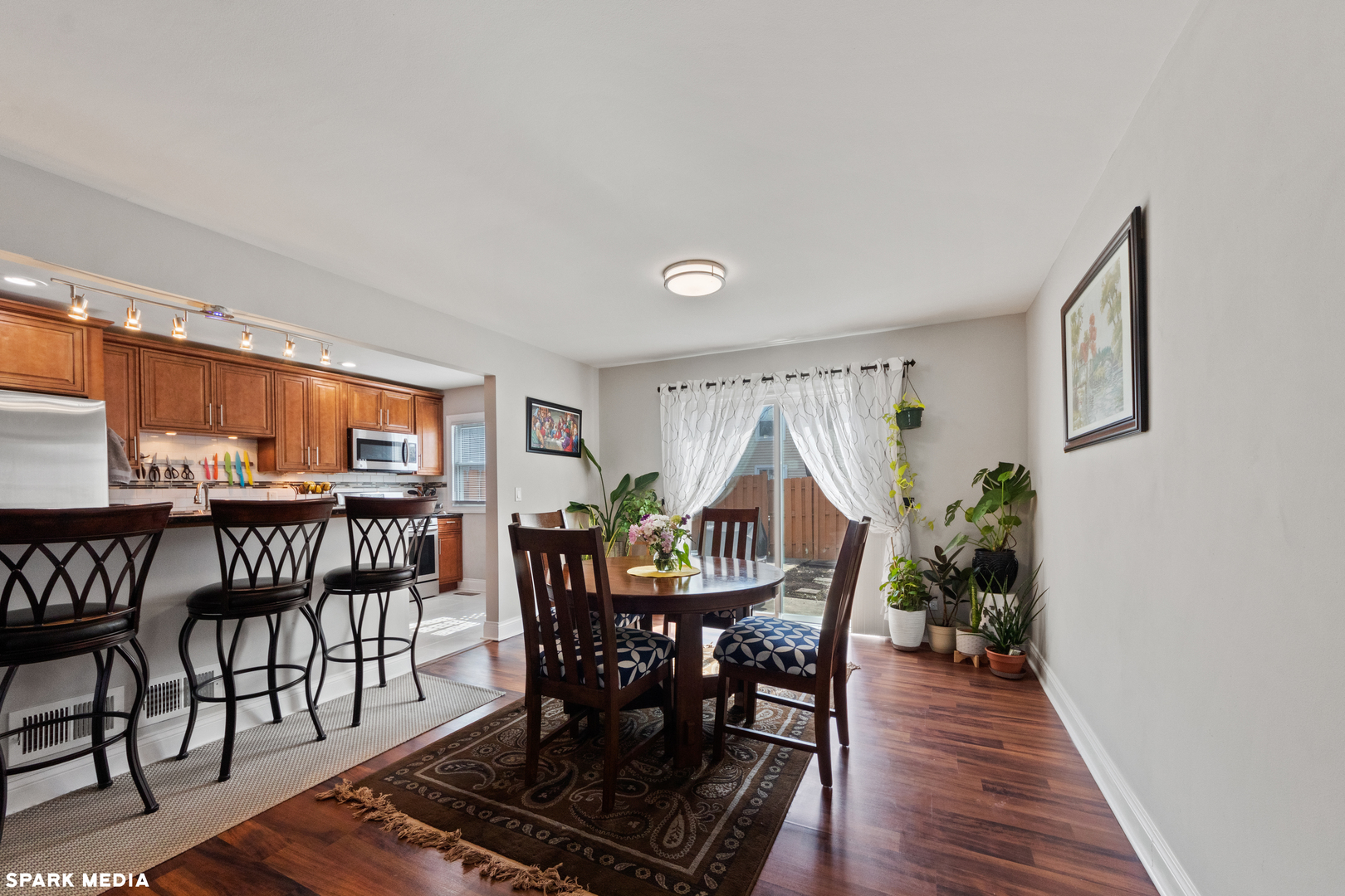 7612 Manchester Manor Hanover Park, IL 60133 - Photo 7 of 30 a view of a dining room with furniture and wooden floor
