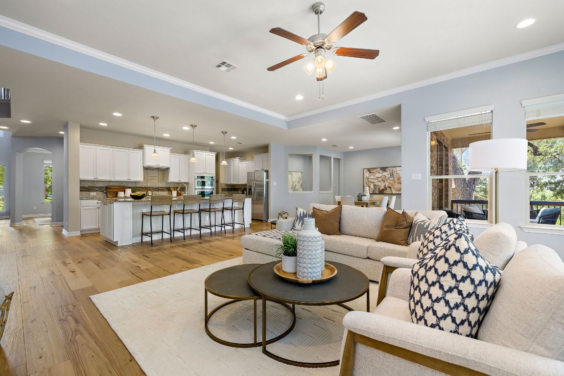 a living room with furniture kitchen and a table