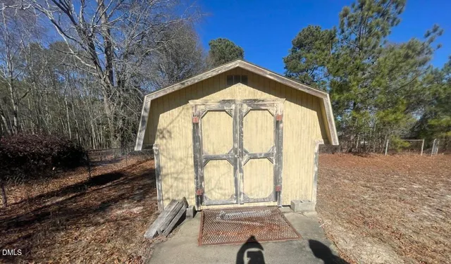 a view of a wooden door with a yard