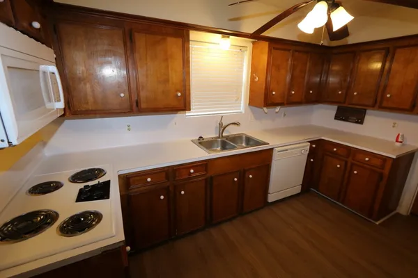 a kitchen with a sink a stove and cabinets