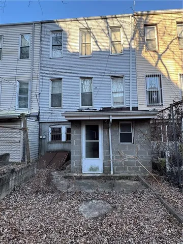 a view of a house with a yard and hanging chair