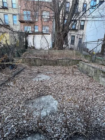 a view of a yard with a large tree