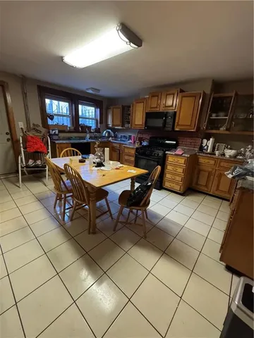 a room with furniture a flat screen tv and a refrigerator