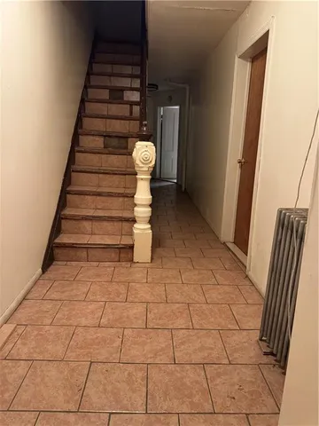 a view of a livingroom with wooden floor and stairs