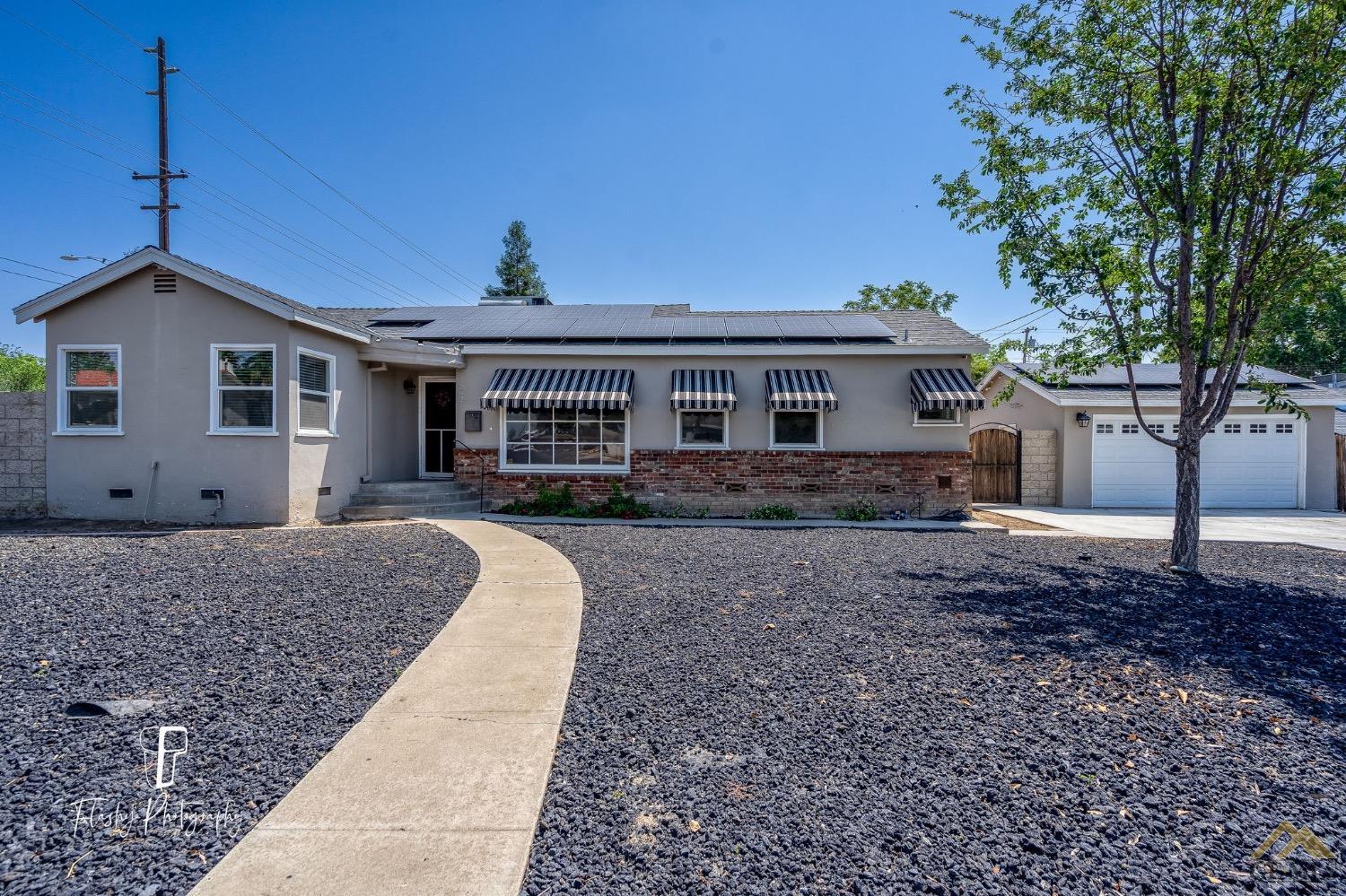Undisclosed Address Bakersfield, CA 93305 - Photo 1 of 20 a front view of a house with a yard
