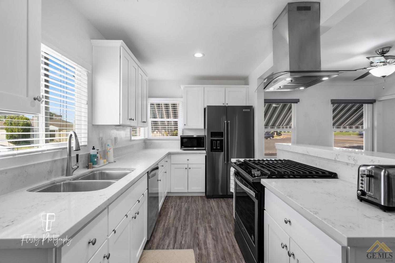 Undisclosed Address Bakersfield, CA 93305 - Photo 12 of 20 a kitchen that has a sink cabinets counter space and stainless steel appliances